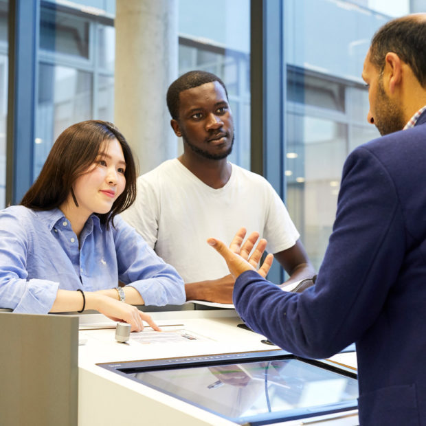 A professor talks to two students