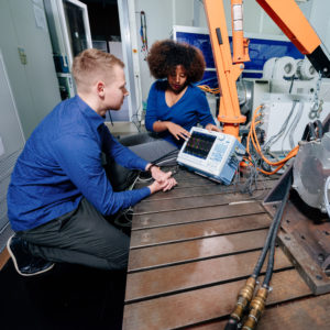 One student shows results from the laboratory to another student